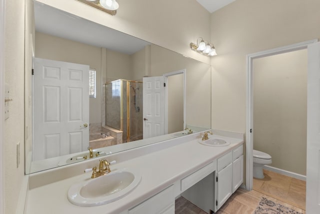 full bathroom featuring vanity, shower with separate bathtub, and toilet