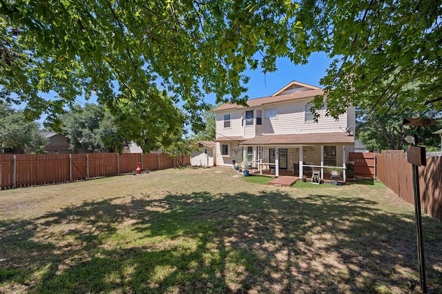 back of house featuring a lawn