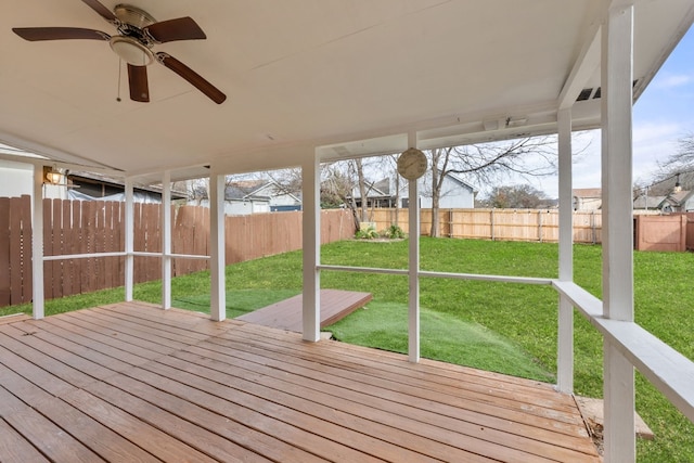 wooden terrace featuring a lawn and ceiling fan