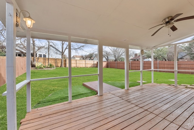 wooden deck with a lawn and ceiling fan