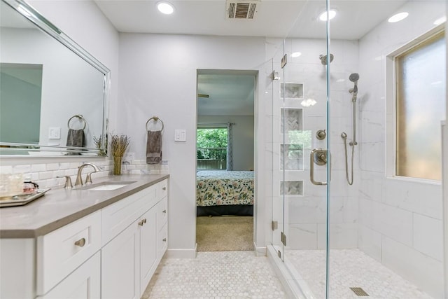 bathroom with vanity, backsplash, and walk in shower