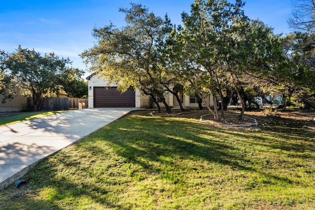 obstructed view of property featuring a garage and a front lawn