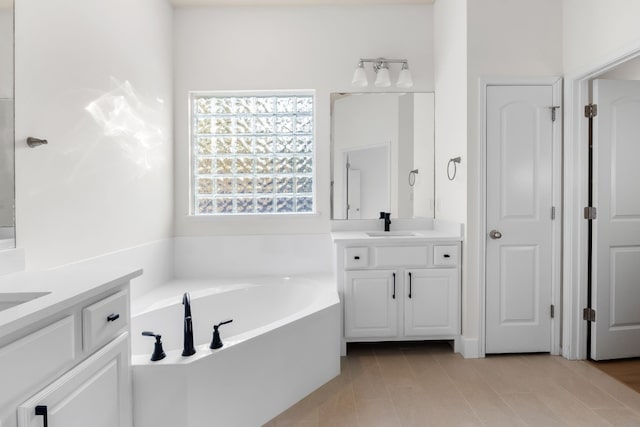 bathroom with vanity, a bath, and tile patterned flooring