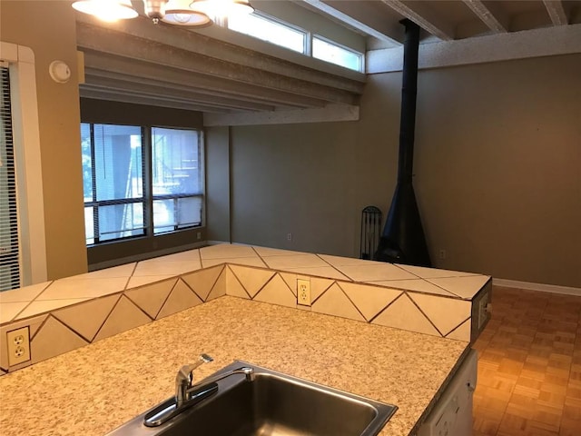 kitchen featuring parquet floors, sink, and a healthy amount of sunlight