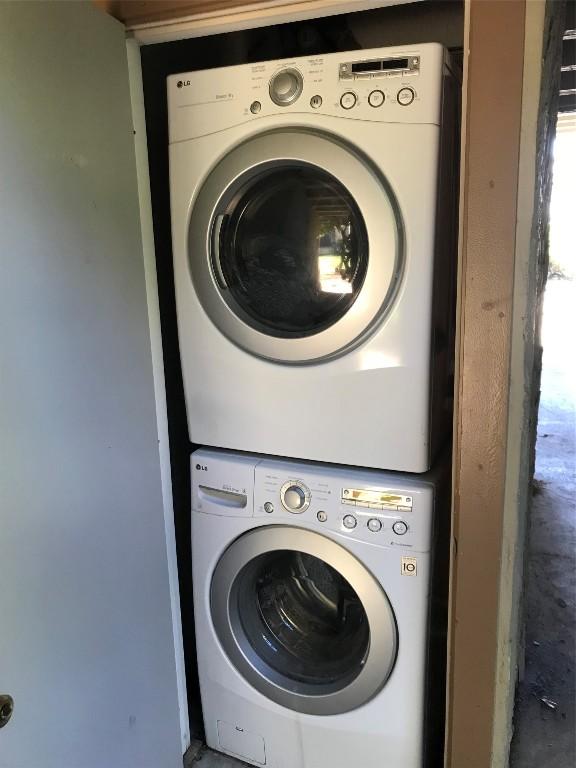 laundry room featuring stacked washer and clothes dryer