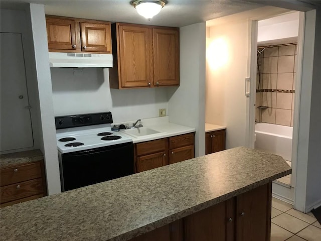 kitchen with light tile patterned flooring, sink, and electric range