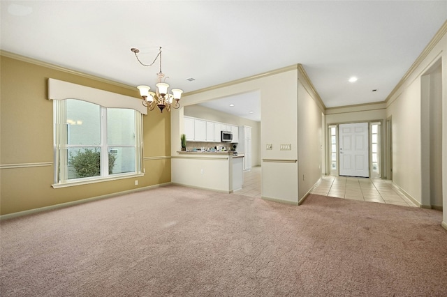 unfurnished living room with an inviting chandelier, ornamental molding, and light carpet