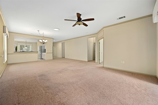 unfurnished living room with ornamental molding, ceiling fan with notable chandelier, and light colored carpet