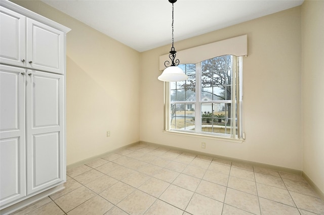 unfurnished dining area with light tile patterned floors