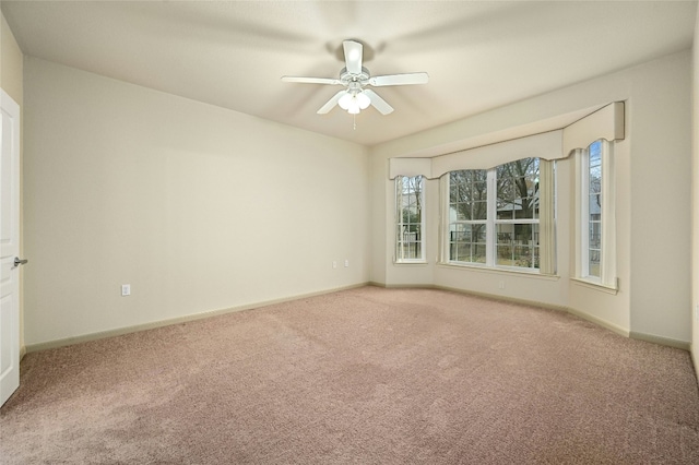 unfurnished room with ceiling fan and carpet flooring