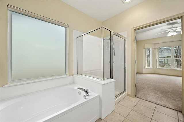 bathroom featuring tile patterned flooring, shower with separate bathtub, and ceiling fan