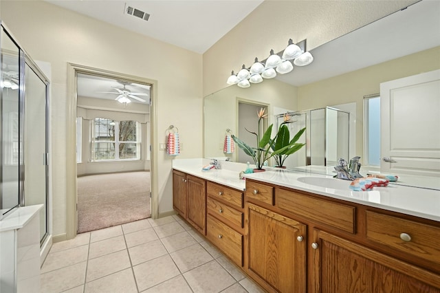 bathroom featuring vanity, tile patterned floors, ceiling fan, and walk in shower