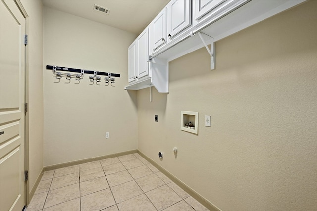 clothes washing area with electric dryer hookup, light tile patterned floors, hookup for a washing machine, and cabinets