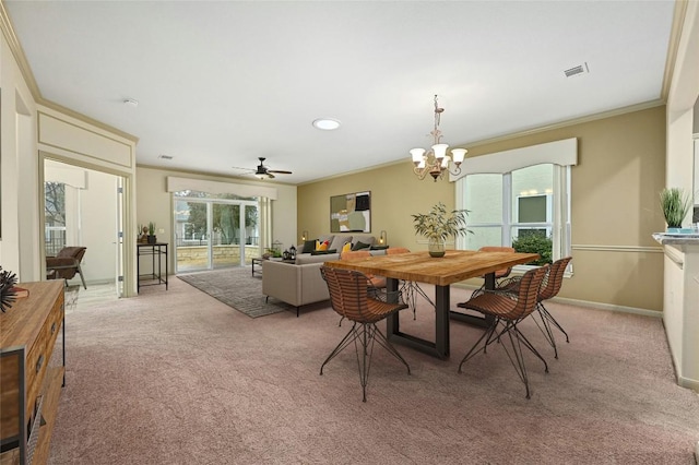 dining space featuring crown molding, ceiling fan with notable chandelier, and light colored carpet