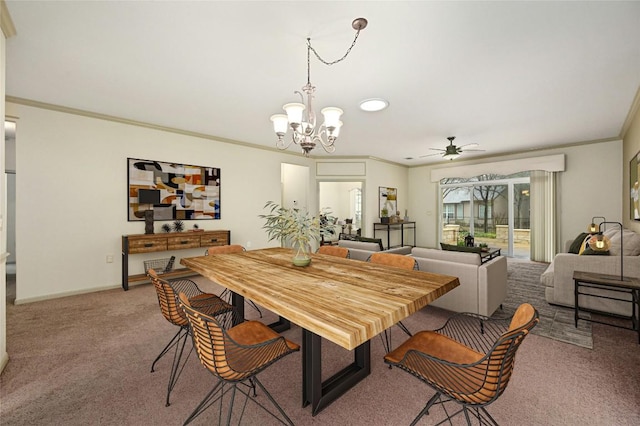 dining room featuring ceiling fan with notable chandelier, ornamental molding, and light colored carpet