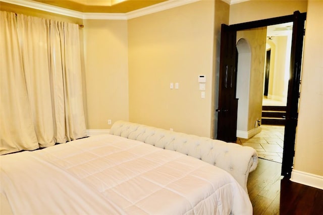 bedroom with wood-type flooring and crown molding