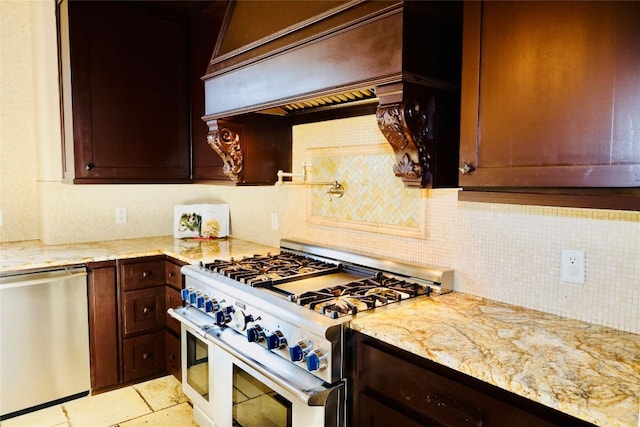 kitchen featuring light tile patterned floors, appliances with stainless steel finishes, light stone counters, decorative backsplash, and custom exhaust hood