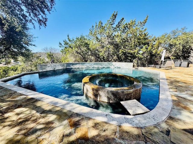 view of pool with an in ground hot tub and a patio area