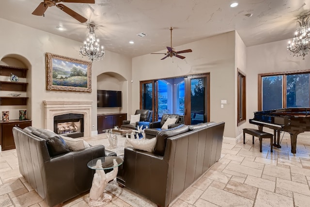 living room featuring ceiling fan with notable chandelier