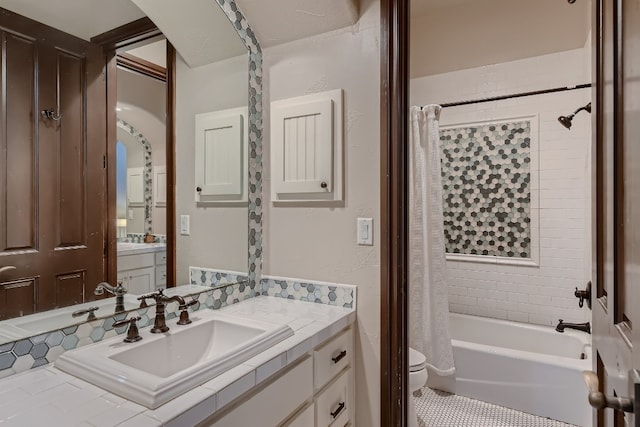 full bathroom with vanity, shower / bath combination with curtain, and toilet