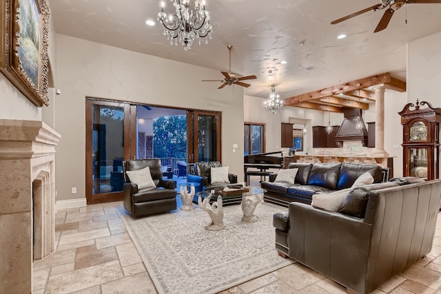 living room featuring ceiling fan with notable chandelier and a premium fireplace