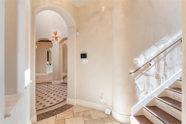 303 Camino Arbolago St, Lakeway, TX 78734 - entrance foyer with arched walkways and stone tile floors