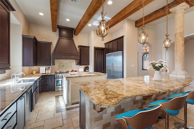 303 Camino Arbolago St, Lakeway, TX 78734 - kitchen with high end appliances, stone tile floors, a kitchen island, recessed lighting, and tasteful backsplash