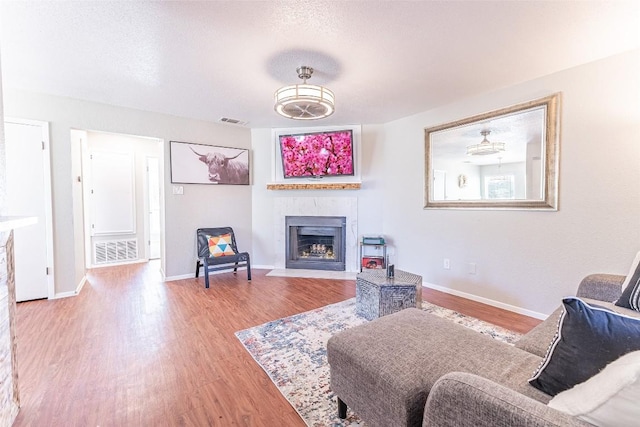 living room featuring a textured ceiling and light hardwood / wood-style floors