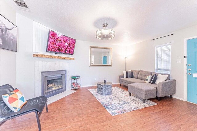 living room with hardwood / wood-style floors and a textured ceiling