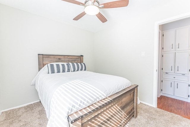 bedroom with light carpet and ceiling fan