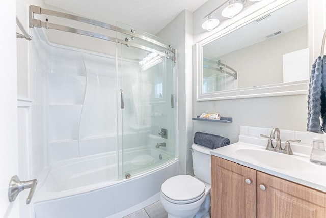 full bathroom featuring vanity, enclosed tub / shower combo, and toilet