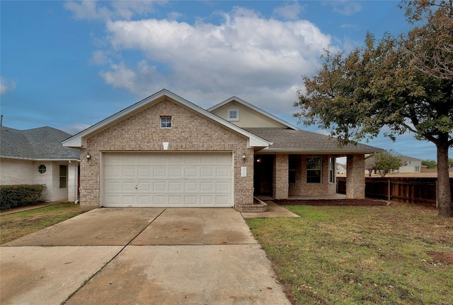 view of front of home featuring a garage and a front yard