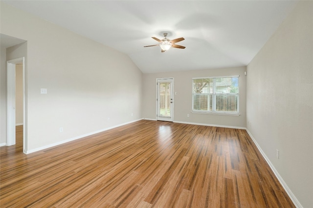 empty room with vaulted ceiling, hardwood / wood-style floors, and ceiling fan