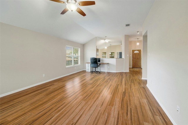 unfurnished living room with vaulted ceiling, light hardwood / wood-style floors, and ceiling fan