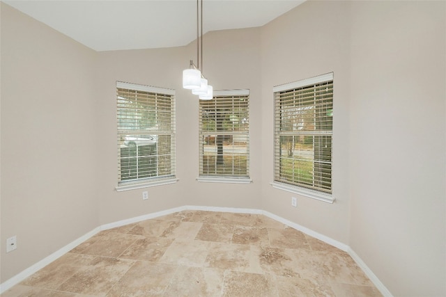 unfurnished room featuring lofted ceiling