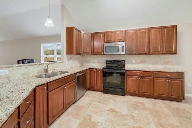 kitchen with tasteful backsplash, appliances with stainless steel finishes, sink, and hanging light fixtures