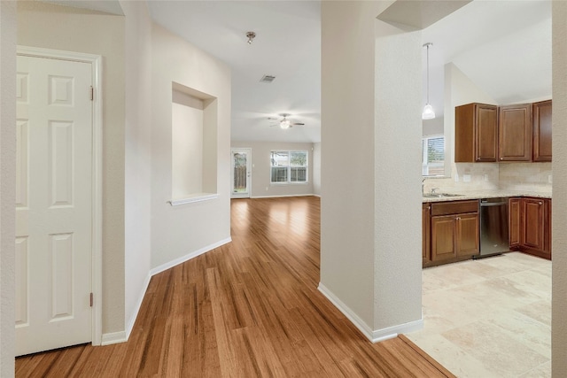 hall featuring lofted ceiling, sink, and light hardwood / wood-style flooring