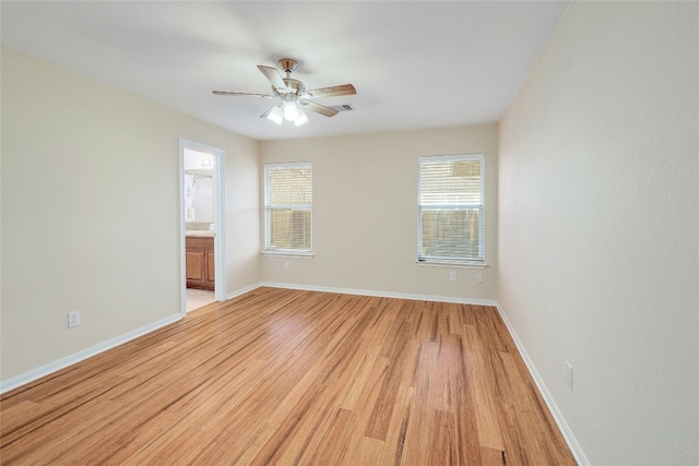 empty room with ceiling fan and light wood-type flooring