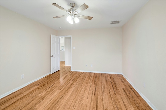 spare room with ceiling fan and light wood-type flooring