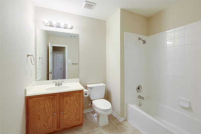 full bathroom featuring tiled shower / bath, tile patterned floors, toilet, and vanity