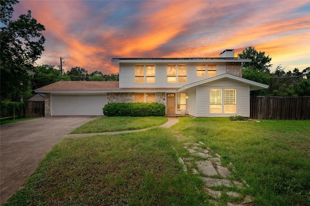 view of front of home featuring a garage and a yard