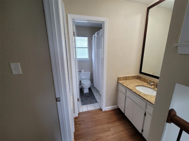 bathroom featuring hardwood / wood-style flooring, vanity, and toilet