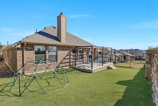 rear view of house featuring a patio and a lawn