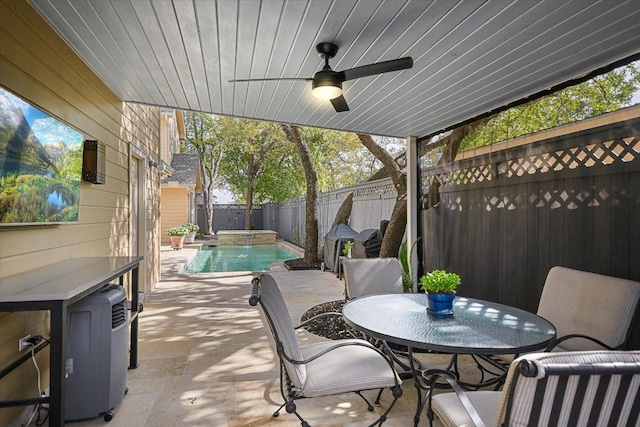 view of patio / terrace featuring a fenced backyard, a fenced in pool, outdoor dining space, and ceiling fan