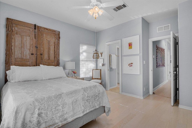bedroom with baseboards, ceiling fan, light wood-style flooring, and visible vents