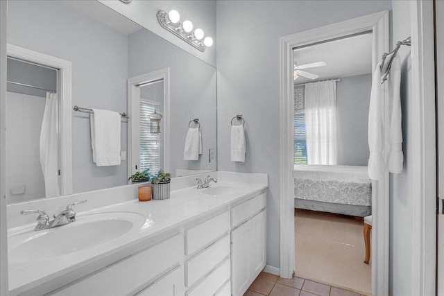 full bath with plenty of natural light, a sink, and tile patterned flooring