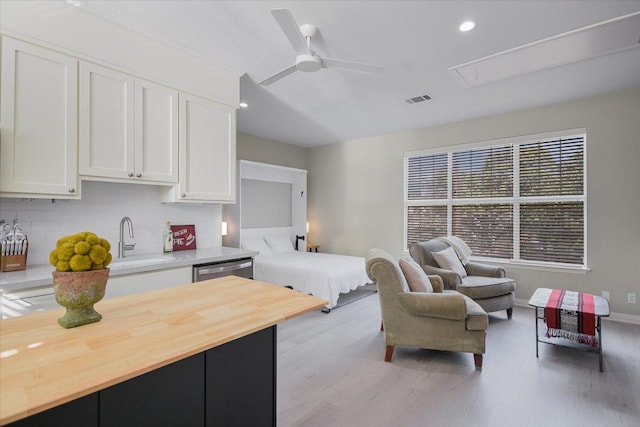 bedroom featuring visible vents, attic access, recessed lighting, a sink, and light wood finished floors