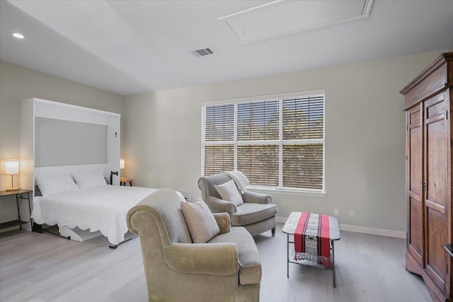 bedroom featuring attic access, visible vents, baseboards, light wood-style floors, and recessed lighting