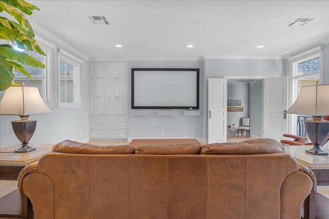home theater room with visible vents, recessed lighting, baseboards, and crown molding