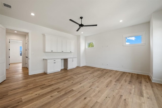 interior space with light wood-type flooring, visible vents, built in desk, and recessed lighting